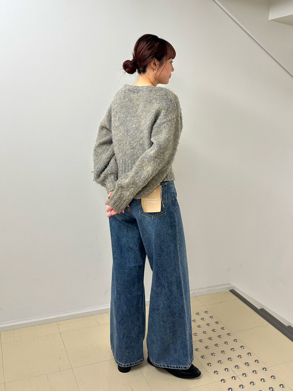 ブルー系のデニムパンツ、グレー系のカーディガン/ボレロを着用したレディースの冬コーディネートの4枚目の写真