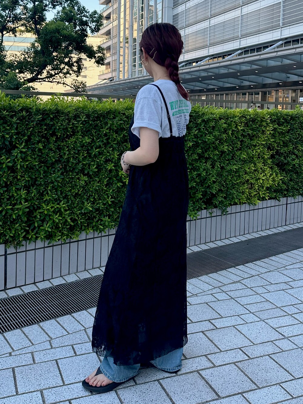 ブルー系のデニムパンツ、ブラック系のワンピース、グレー系のTシャツ/カットソーを着用したレディースの夏コーディネートの3枚目の写真