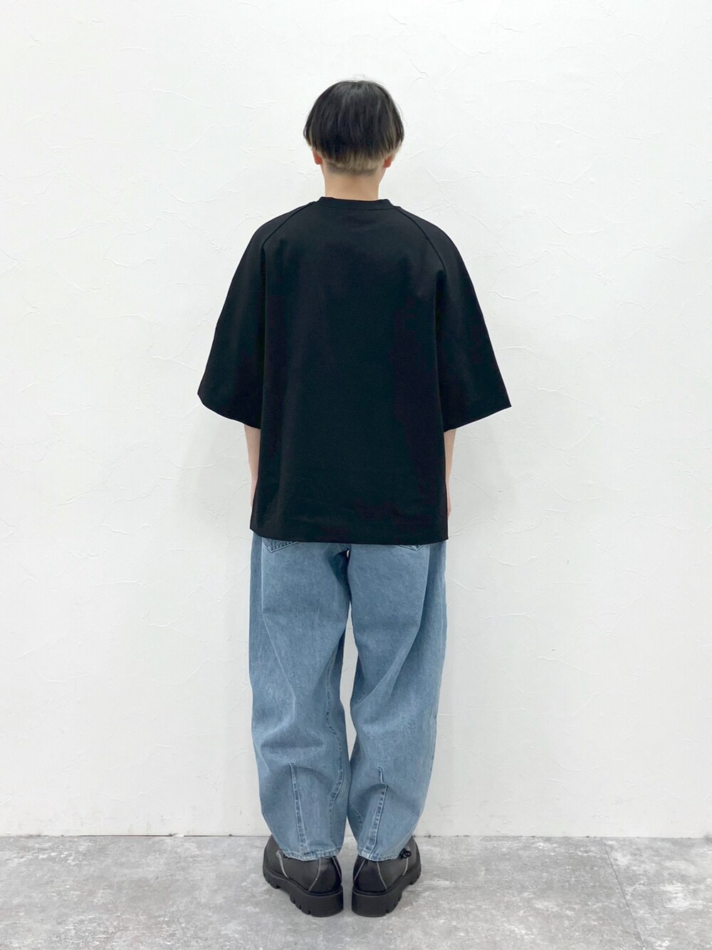 ブラック系のTシャツ/カットソー、ブルー系のデニムパンツを着用したメンズの春コーディネートの7枚目の写真