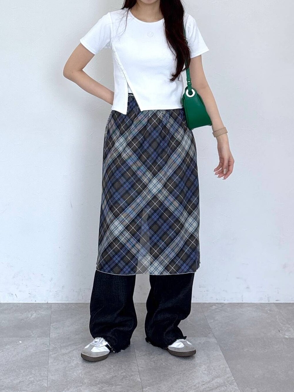 ブラック系のデニムパンツ、ブルー系のスカートを着用したレディースの春コーディネートの2枚目の写真