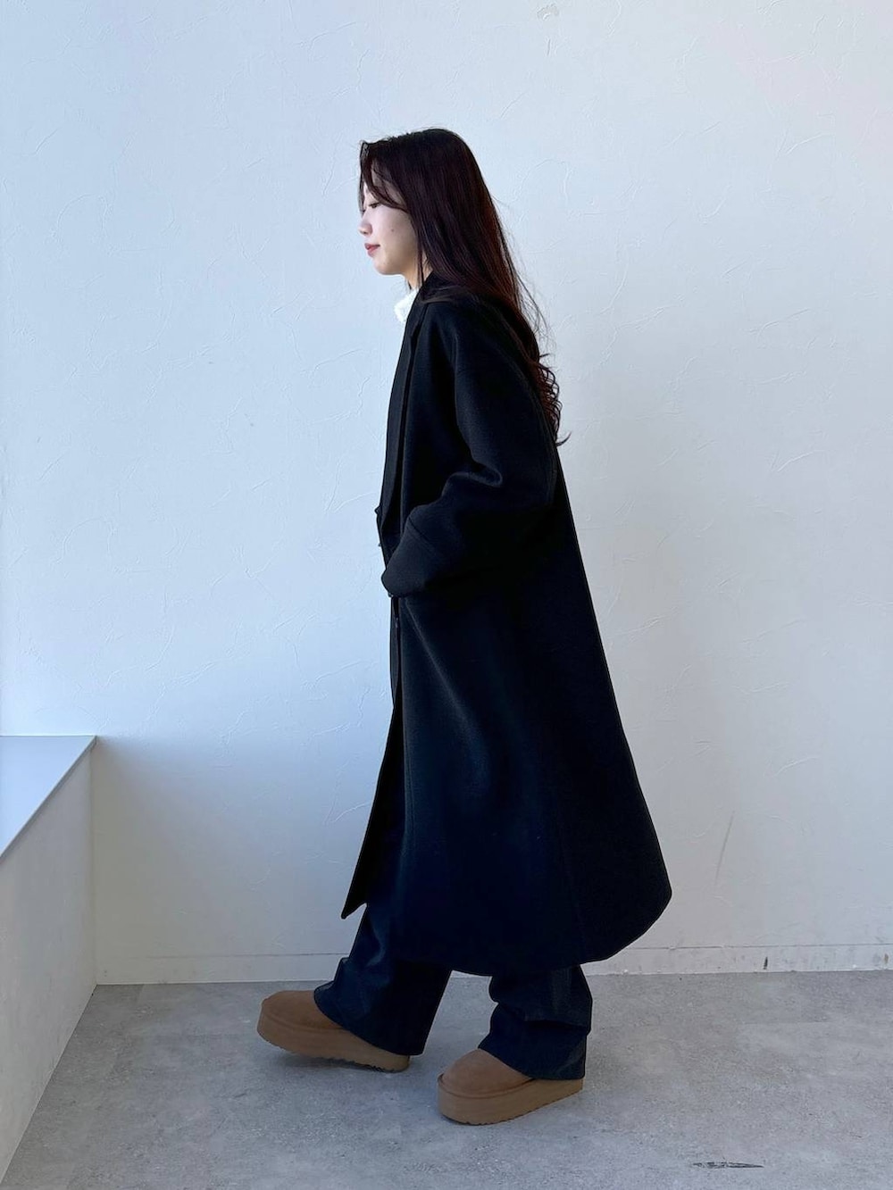 ホワイト系のTシャツ/カットソー、ブラウン系のその他パンツ、グレー系のチェスターコートを着用したレディースの冬コーディネートの3枚目の写真