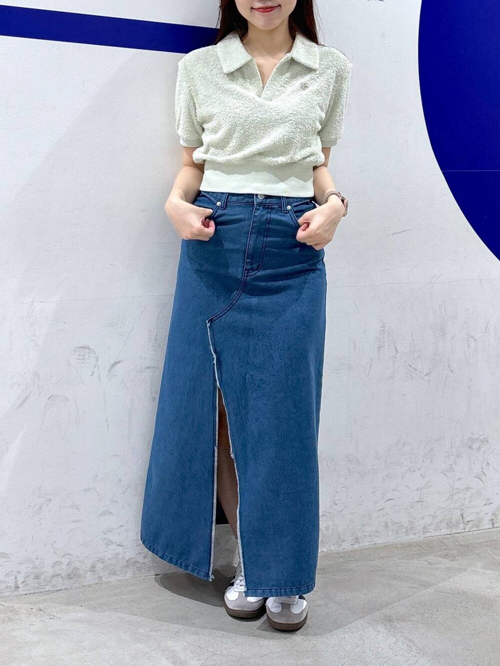 ブルー系のスカート、グリーン系のTシャツ/カットソーを着用したレディースの夏コーディネートの2枚目の写真