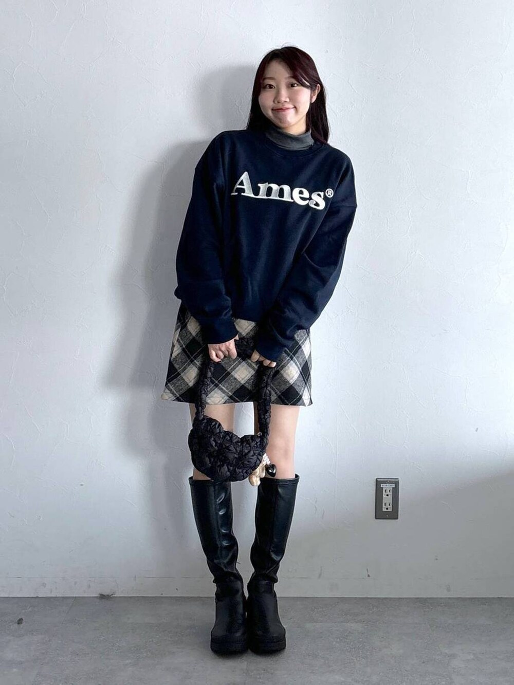 ブラック系のショルダーバッグ、その他のスウェット、ブラック系のスカートを着用したレディースの冬コーディネートの2枚目の写真