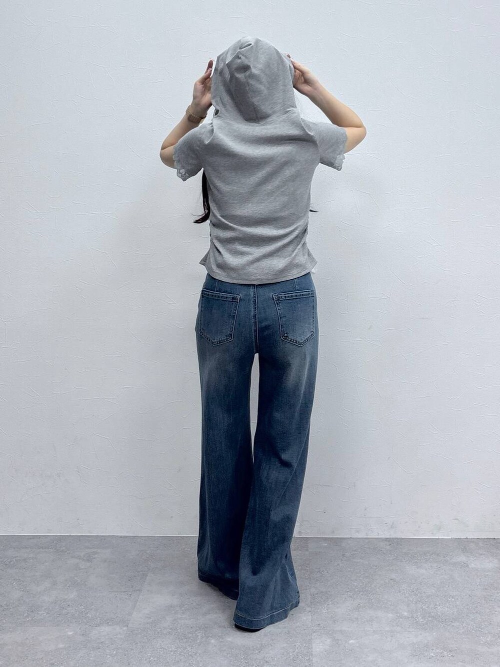 グレー系のTシャツ/カットソー、ブルー系のデニムパンツを着用したレディースの春コーディネートの4枚目の写真