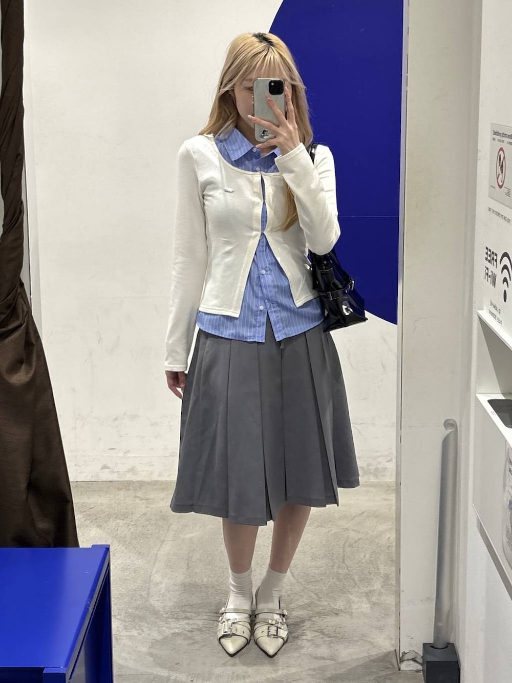 ホワイト系のパンプス、ブラック系のショルダーバッグ、ベージュ系のカーディガン/ボレロを着用したレディースの冬コーディネートの5枚目の写真