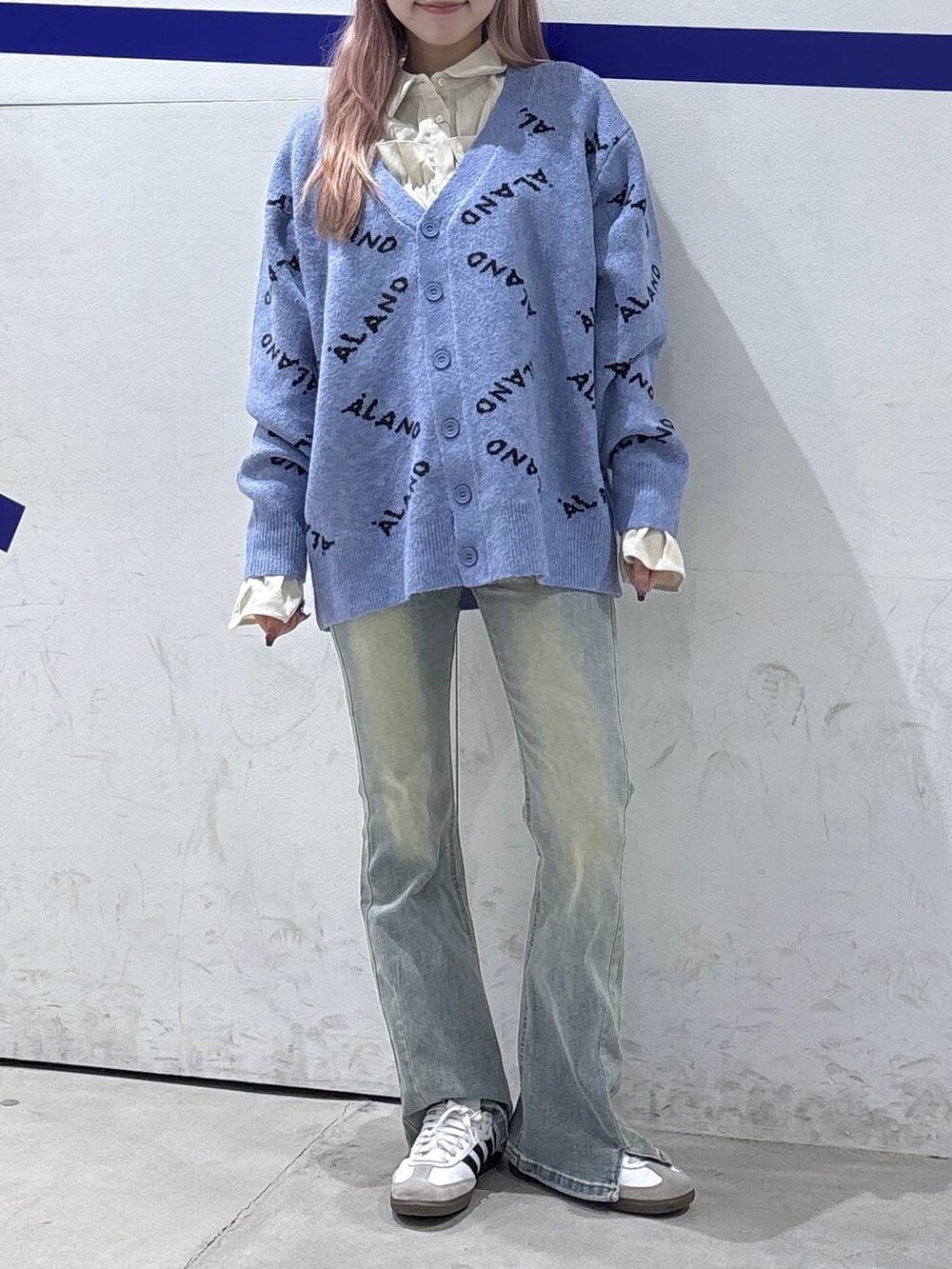 ブルー系のカーディガン/ボレロ、ベージュ系のシャツ/ブラウス、ブラック系のデニムパンツを着用したレディースの秋コーディネートの2枚目の写真