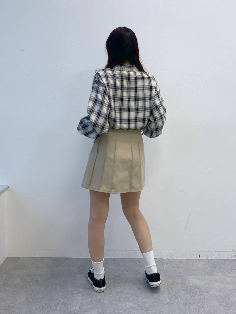 ベージュ系のスカート、ブラック系のシャツ/ブラウスを着用したレディースの冬コーディネートの5枚目の写真