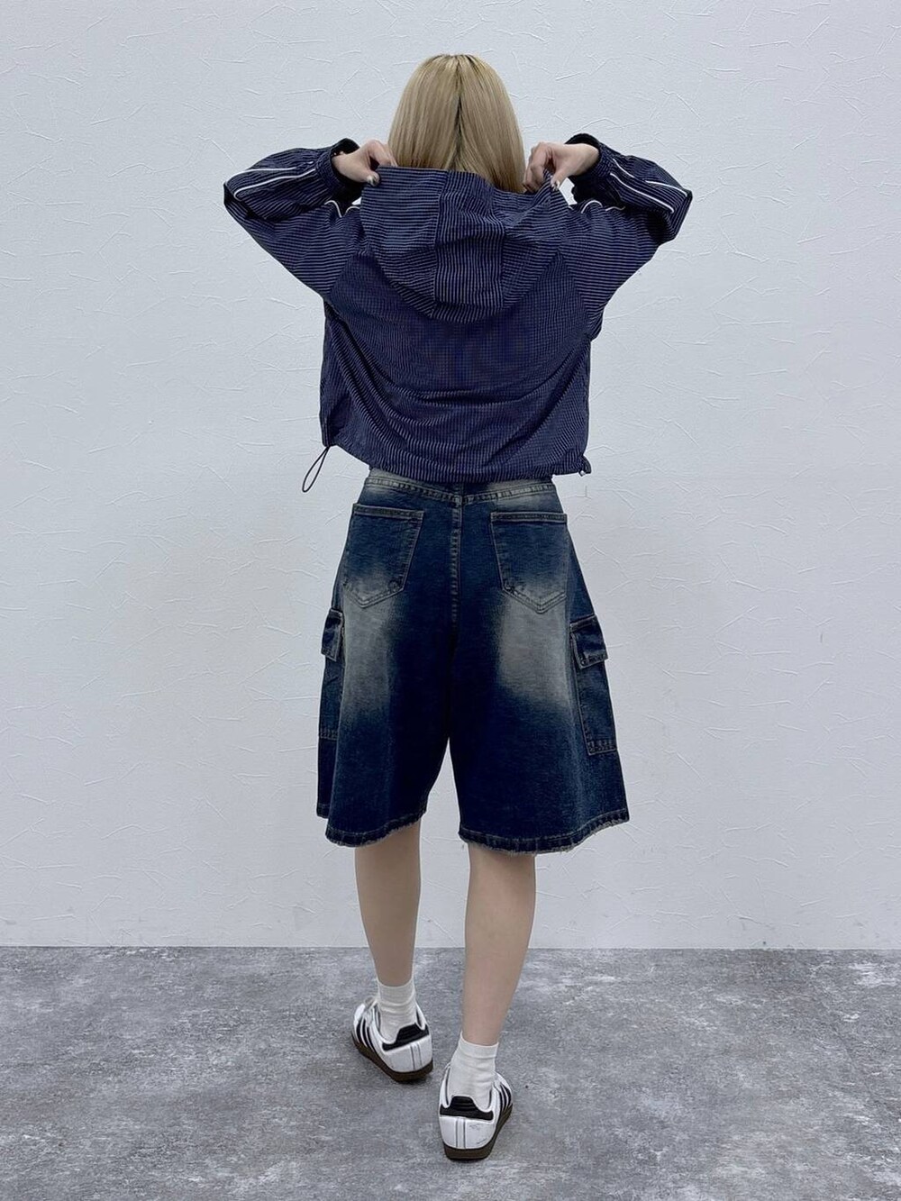 ブルー系のブルゾン、ブルー系のデニムパンツを着用したレディースの春コーディネートの4枚目の写真