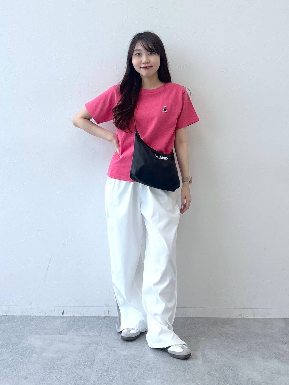 ベージュ系のカーゴパンツ、ピンク系のTシャツ/カットソー、ブラック系のショルダーバッグを着用したレディースの春コーディネートの2枚目の写真