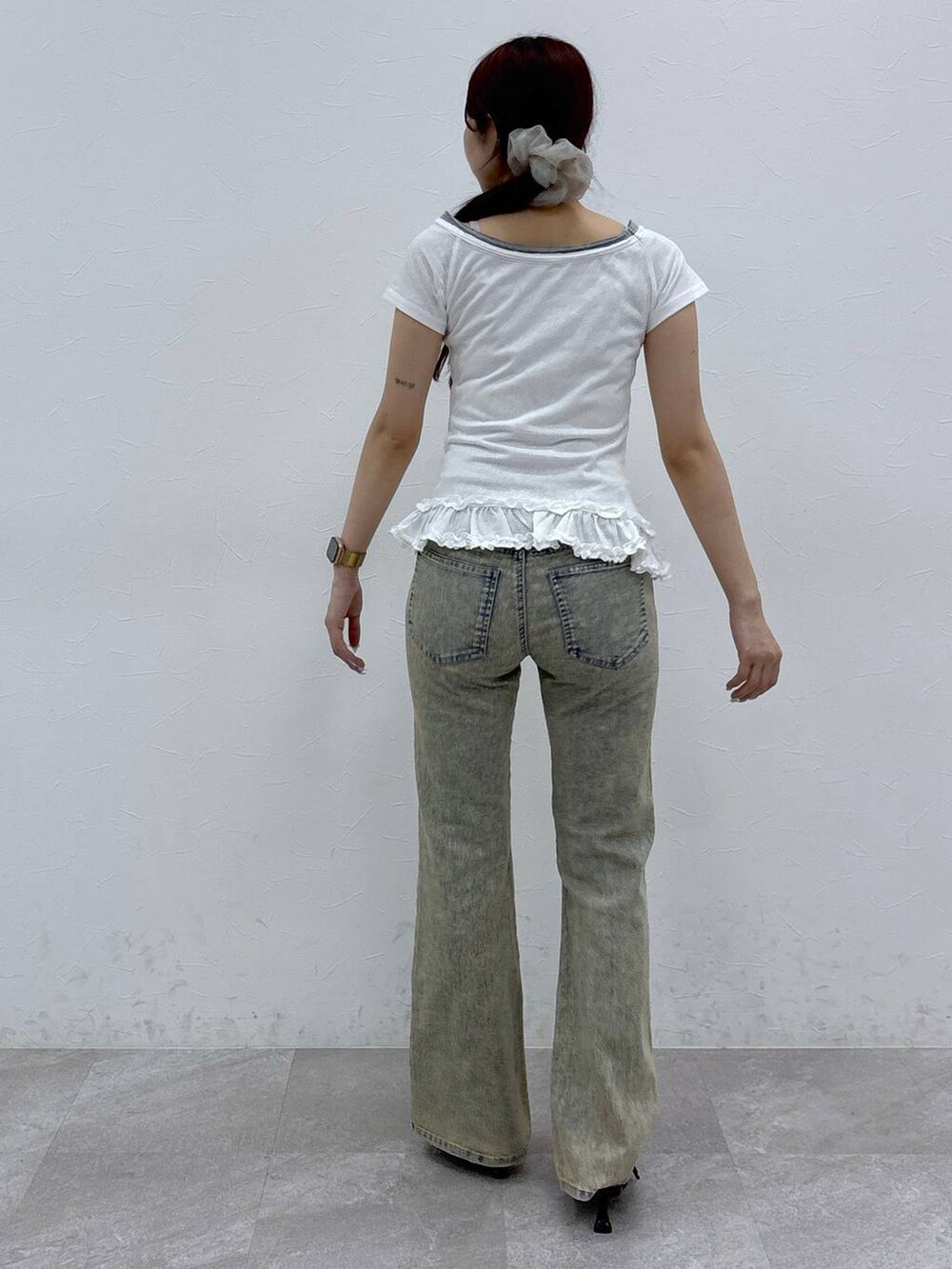 ブラック系のサンダル、ブルー系のデニムパンツを着用したレディースの夏コーディネートの4枚目の写真