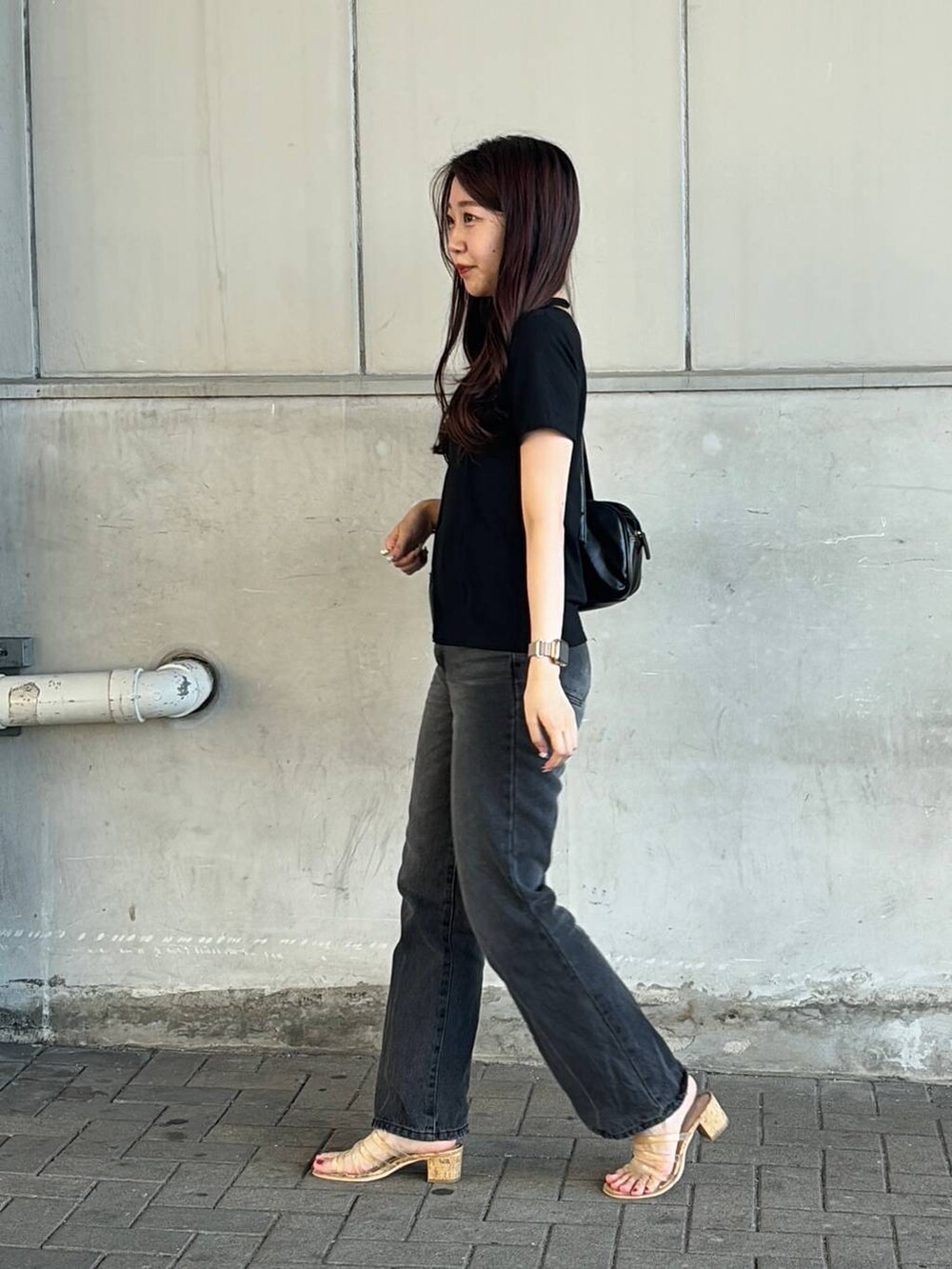 ブラック系のハンドバッグ、ブラック系のTシャツ/カットソーを着用したレディースの夏コーディネートの2枚目の写真