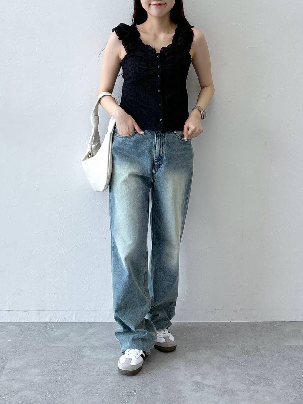 ブラック系のシャツ/ブラウス、ブルー系のデニムパンツを着用したレディースの夏コーディネートの2枚目の写真