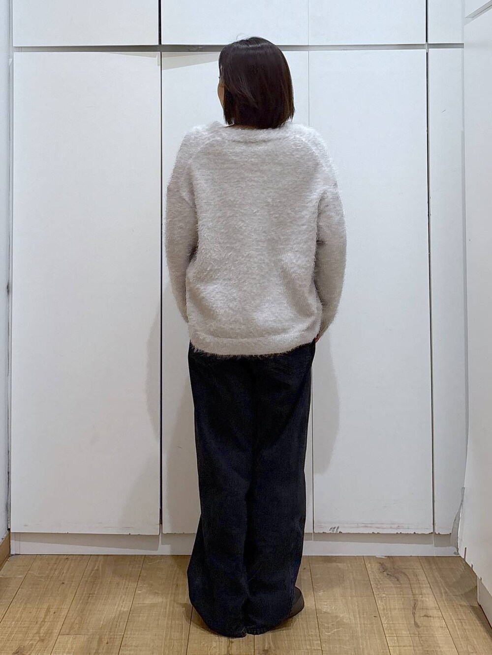 ブラック系のデニムパンツ、ベージュ系のカーディガン/ボレロ、グリーン系のその他シューズを着用したレディースの秋コーディネートの4枚目の写真