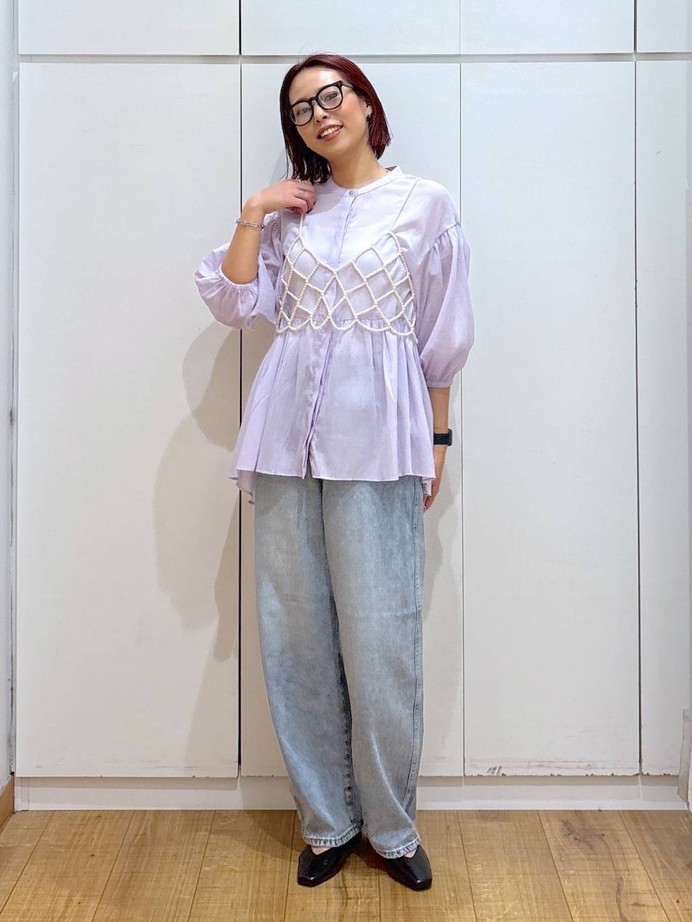 ホワイト系のベスト、ブルー系のデニムパンツ、ベージュ系のトレンチコートを着用したレディースの春コーディネートの6枚目の写真