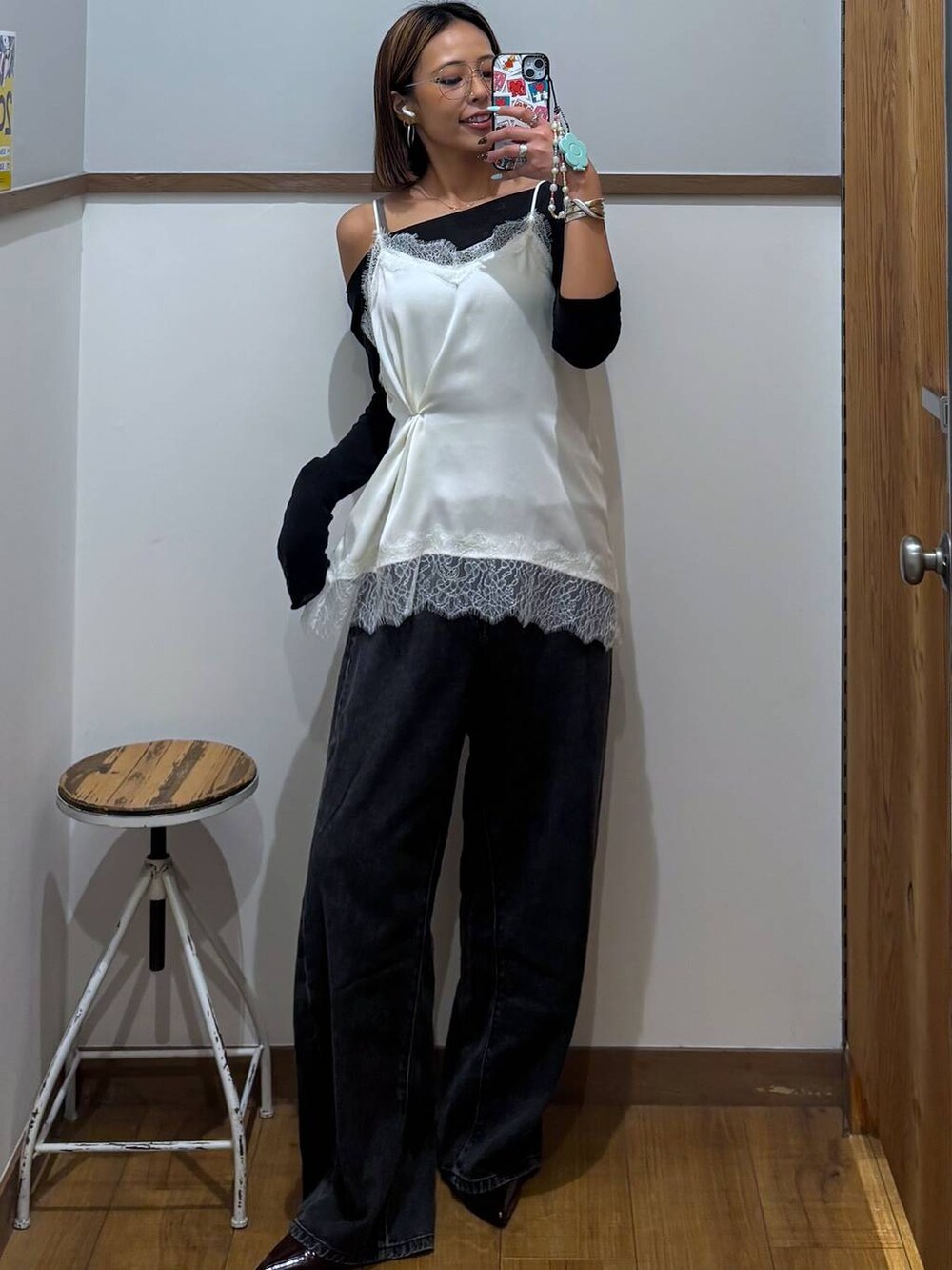 ブラック系のデニムパンツ、ホワイト系のキャミソール、ホワイト系のメガネを着用したレディースの春コーディネートの2枚目の写真