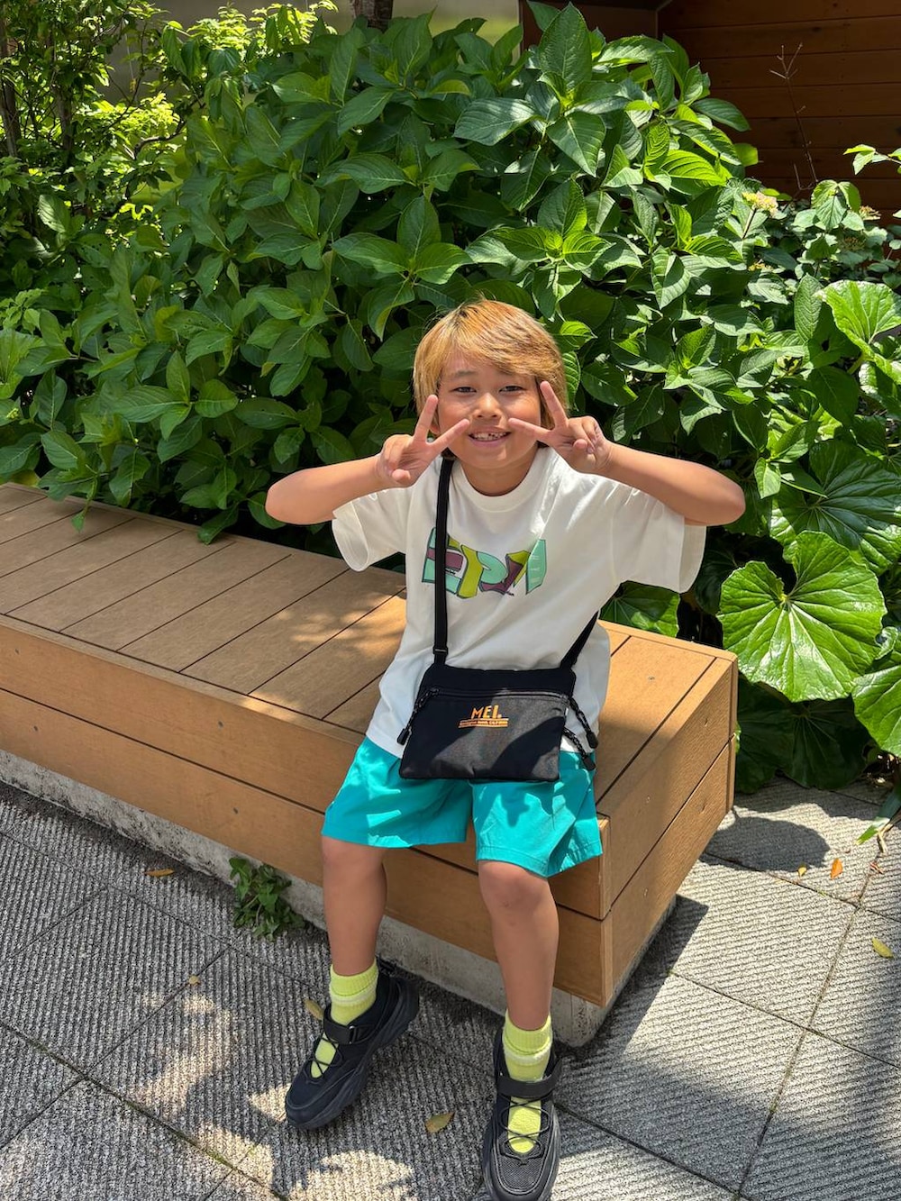 ホワイト系のTシャツ/カットソー、ブラック系のスニーカーを着用したキッズの春コーディネートの2枚目の写真