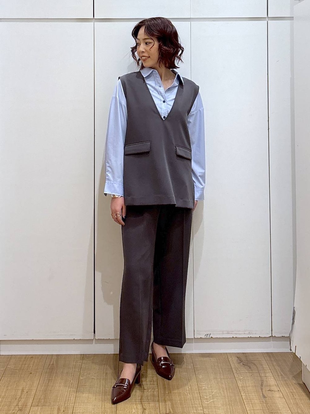 ブルー系のシャツ/ブラウス、グレー系のセットアップ、ブラウン系のローファーを着用したレディースの春コーディネートの2枚目の写真