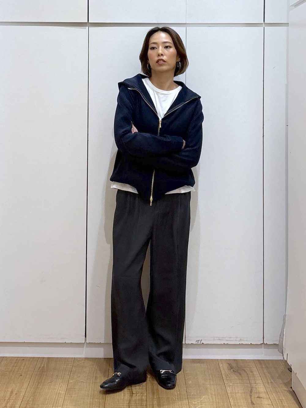 ブラック系のローファー、ブルー系のパーカー、グレー系のその他パンツを着用したレディースの秋コーディネートの6枚目の写真