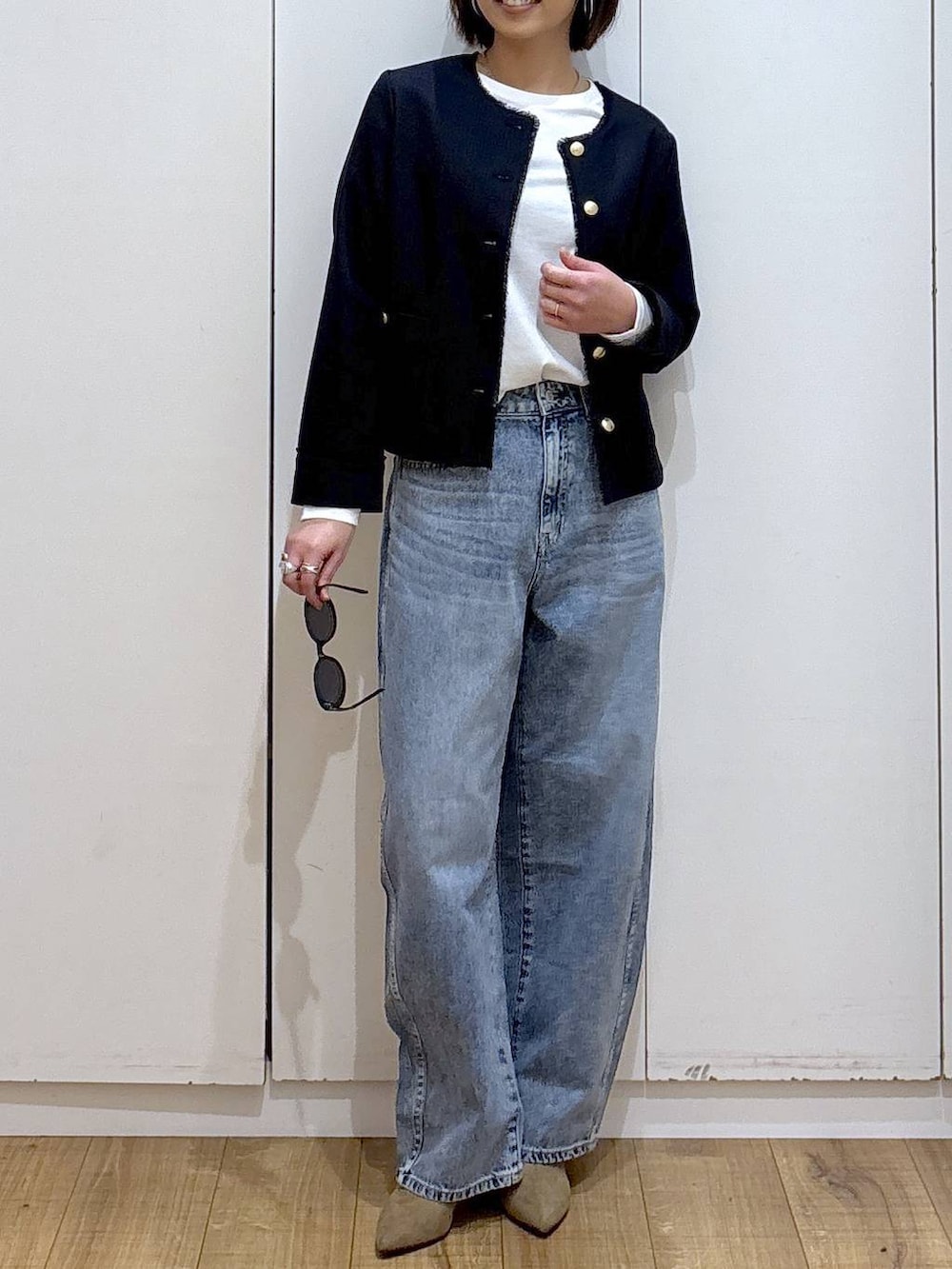 ホワイト系のTシャツ/カットソー、ブルー系のテーラードジャケット、ベージュ系のブーツを着用したレディースの冬コーディネートの5枚目の写真