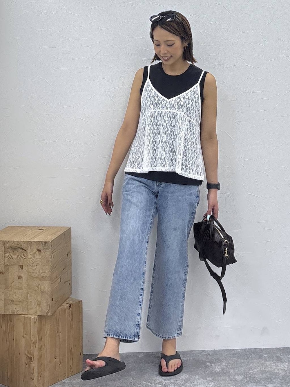 ブラック系のボストンバッグ、ブラック系のTシャツ/カットソー、ホワイト系のキャミソールを着用したレディースの夏コーディネートの2枚目の写真