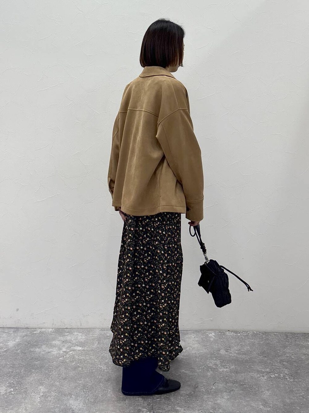 ブラック系のブーツ、ブラウン系のテーラードジャケット、ゴールド系のピアス(両耳用)を着用したレディースの冬コーディネートの3枚目の写真