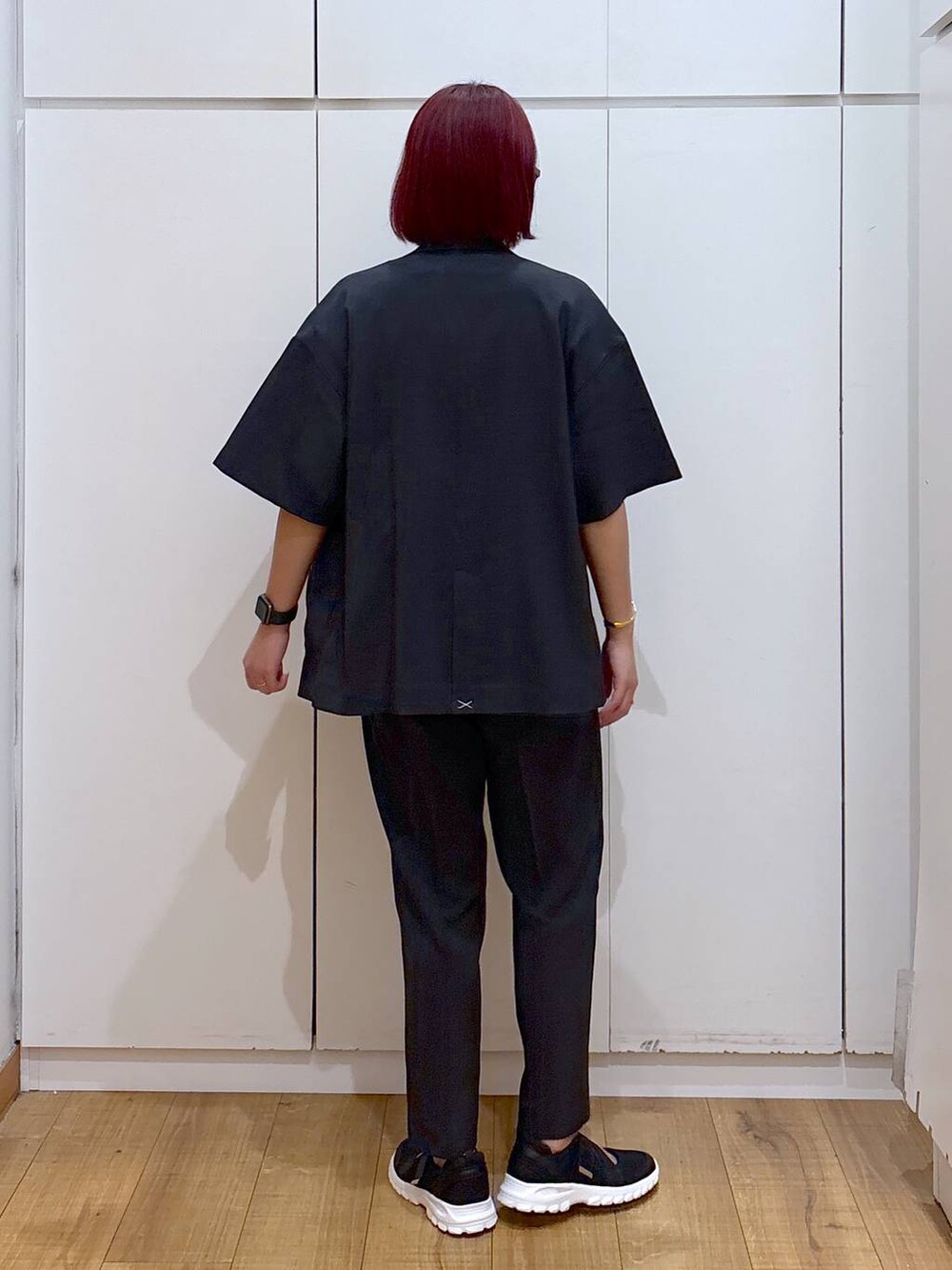 ブラック系のスニーカー、ブラック系のテーラードジャケット、ホワイト系のTシャツ/カットソーを着用したレディースの春コーディネートの5枚目の写真