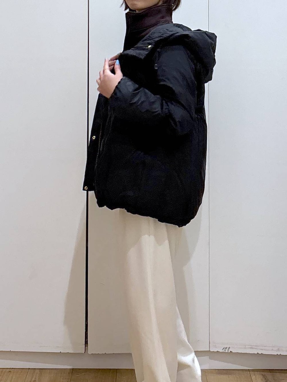 ブラック系のダウンジャケット/コート、ホワイト系のTシャツ/カットソー、グレー系のその他パンツを着用したレディースの冬コーディネートの4枚目の写真