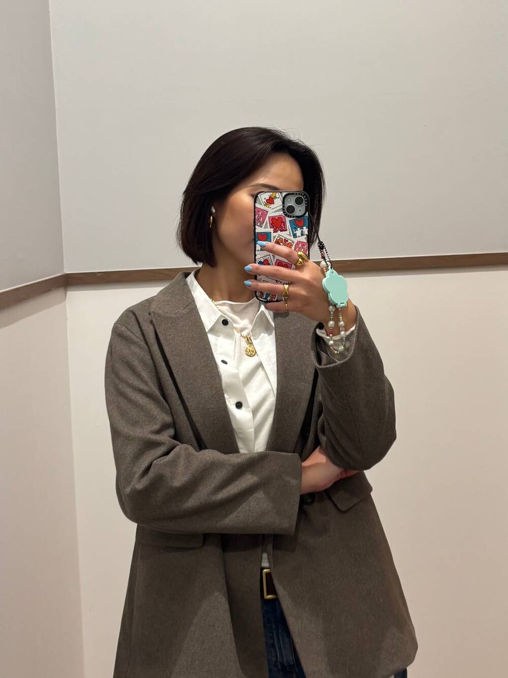 ホワイト系のシャツ/ブラウス、ブラウン系のブーツ、ブルー系のデニムパンツを着用したレディースの冬コーディネートの3枚目の写真