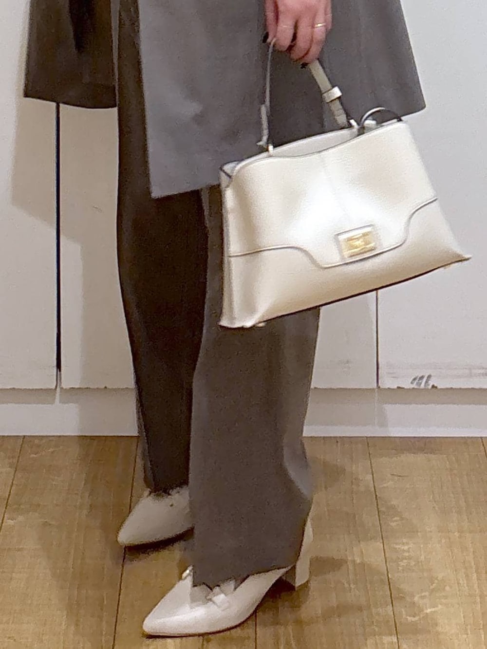 ブラウン系のスラックス、ホワイト系のシャツ/ブラウス、ブラウン系のその他アウターを着用したレディースの冬コーディネートの7枚目の写真