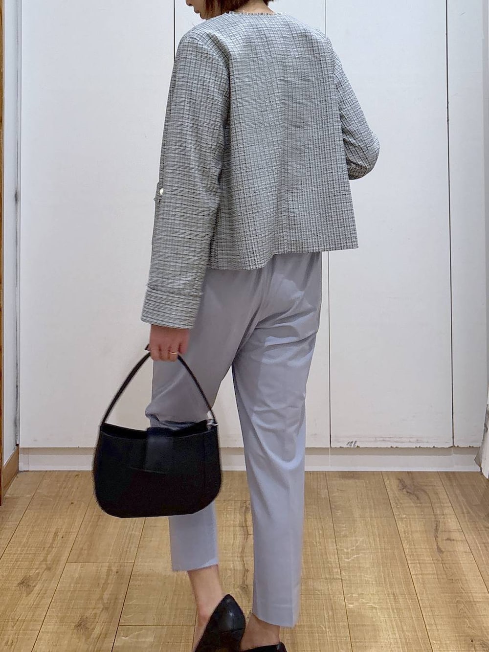 ブラック系のパンプス、ブルー系のスラックス、ホワイト系のシャツ/ブラウスを着用したレディースの冬コーディネートの7枚目の写真