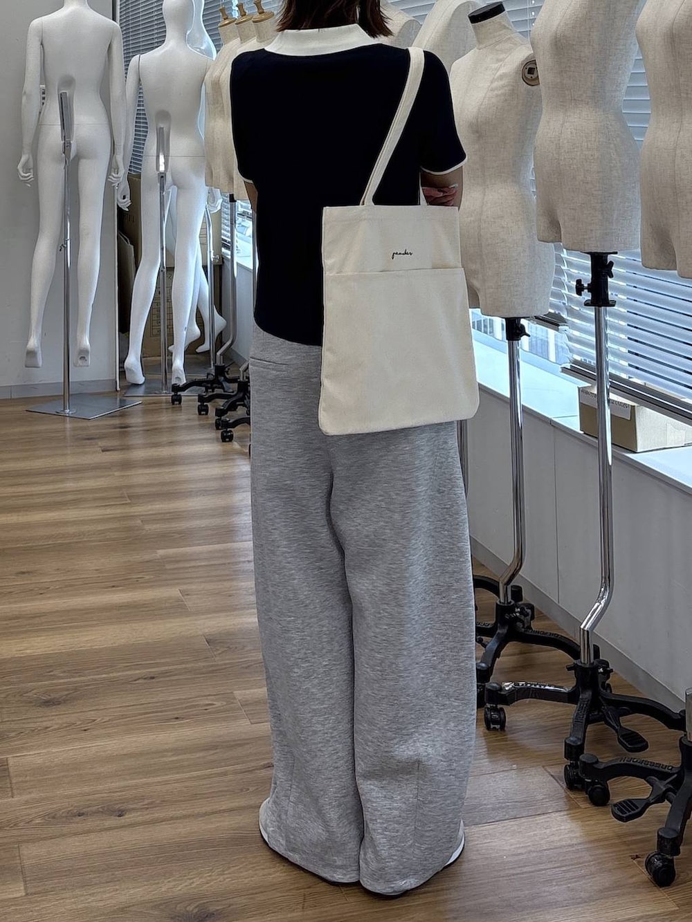 ホワイト系のトートバッグ、グレー系のその他パンツ、ブルー系のニット/セーターを着用したレディースの夏コーディネートの4枚目の写真