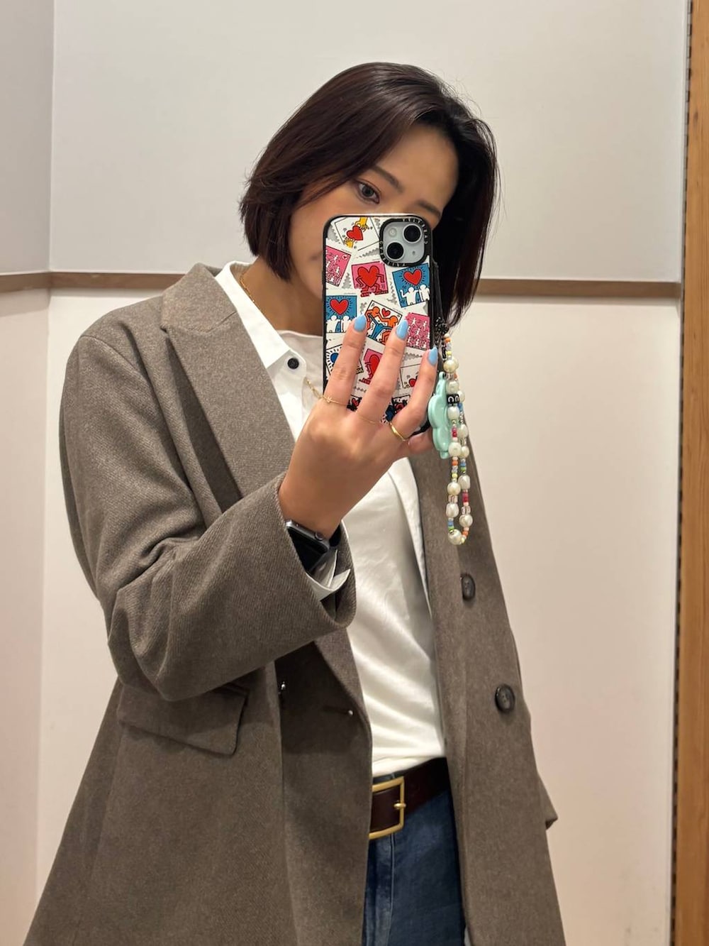 ホワイト系のシャツ/ブラウス、ブラウン系のブーツ、ブルー系のデニムパンツを着用したレディースの冬コーディネートの2枚目の写真