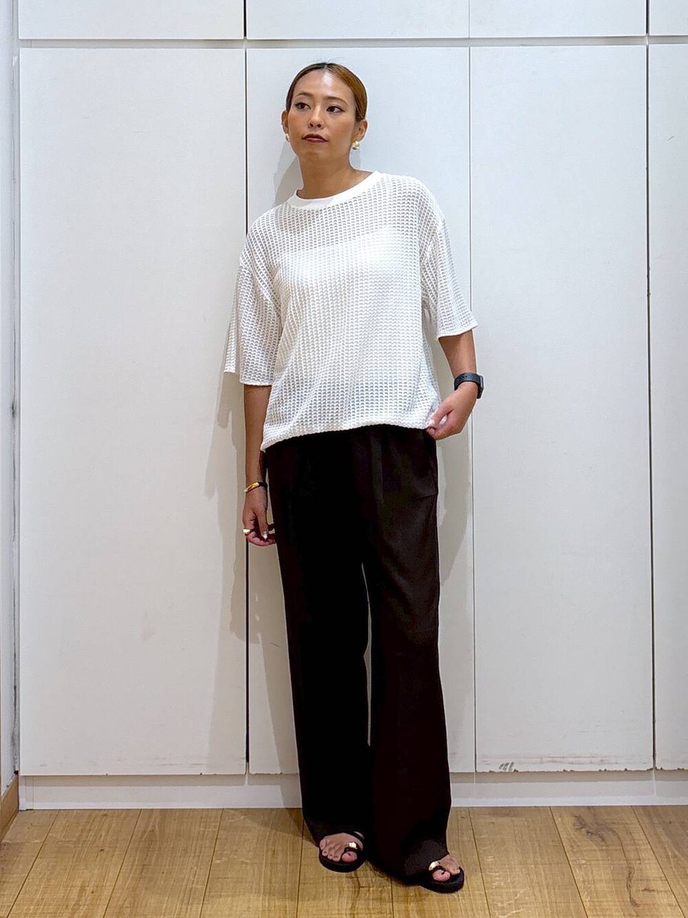 ホワイト系のキャミソール、ブラック系のサンダル、ブラウン系のその他パンツを着用したレディースの夏コーディネートの2枚目の写真