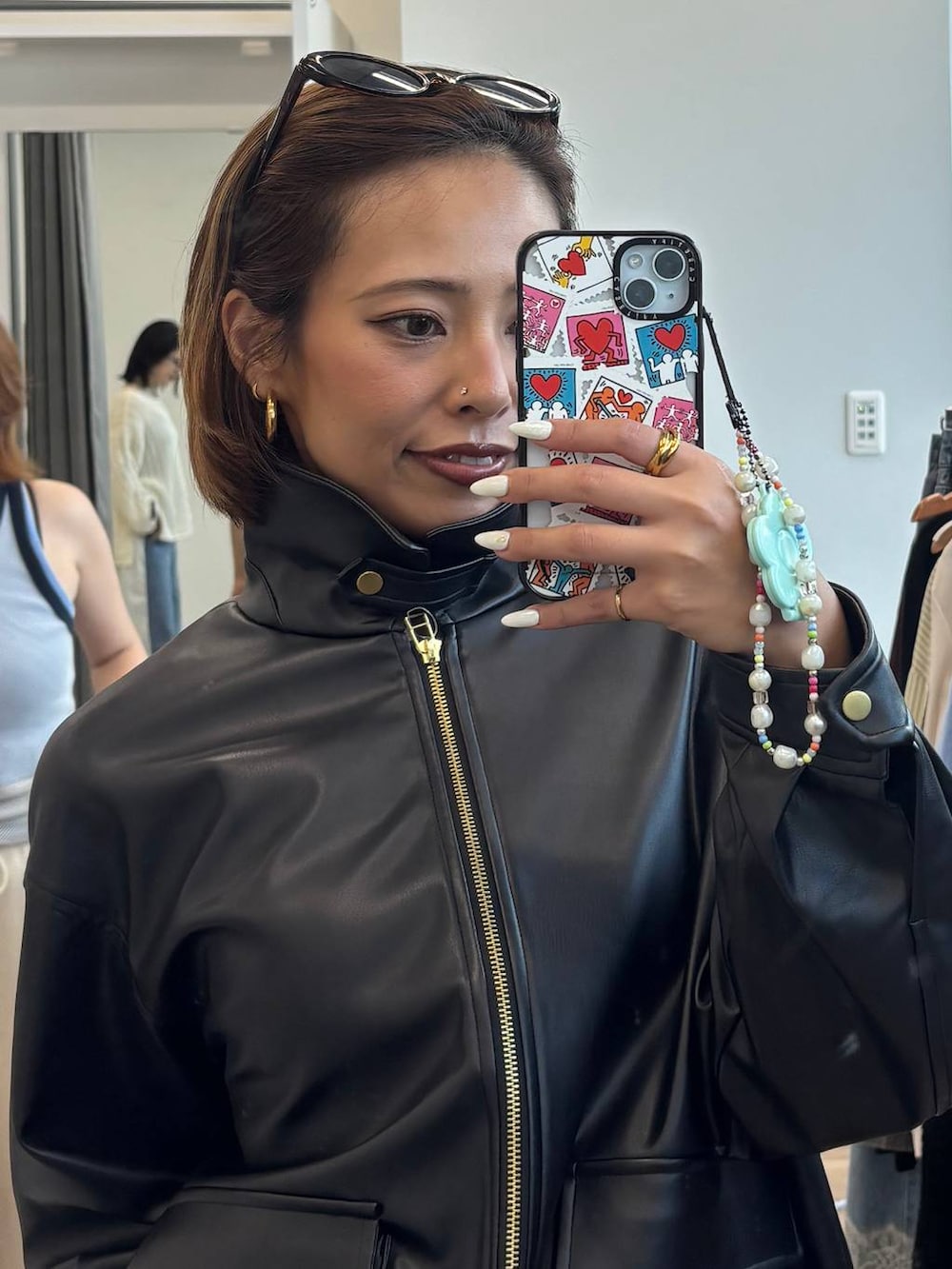ブラック系のスカート、ブラック系のブルゾンを着用したレディースの夏コーディネートの4枚目の写真