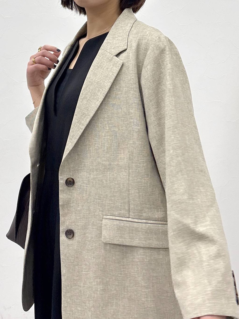 ブラウン系のショルダーバッグ、ベージュ系のテーラードジャケット、ブラック系のサロペット/オーバーオールを着用したレディースの冬コーディネートの7枚目の写真