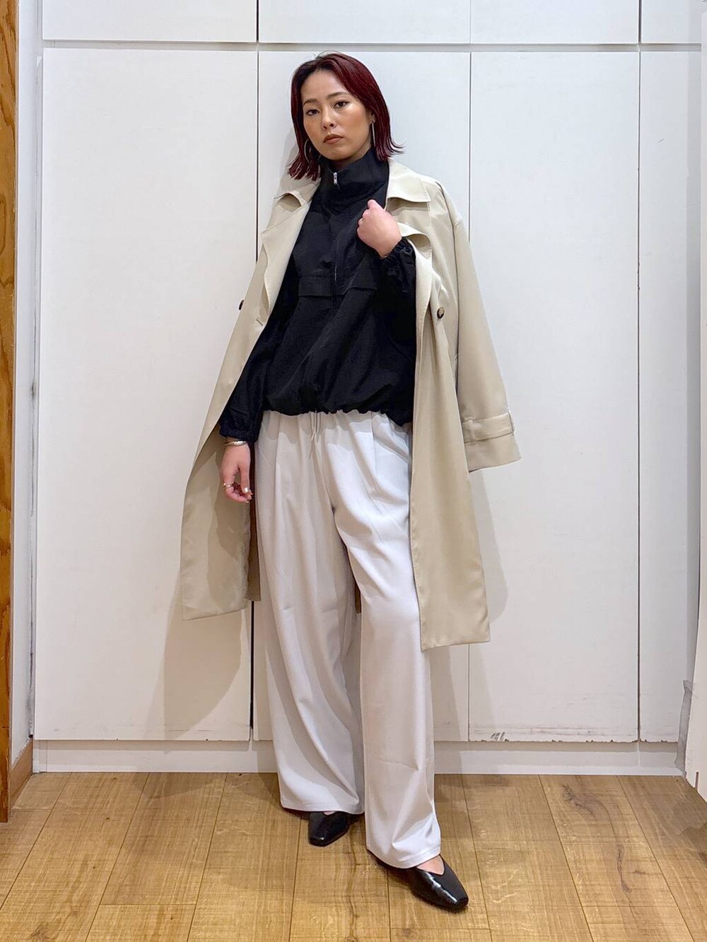 ベージュ系のトレンチコート、グレー系のその他パンツ、ホワイト系のブルゾンを着用したレディースの春コーディネートの3枚目の写真