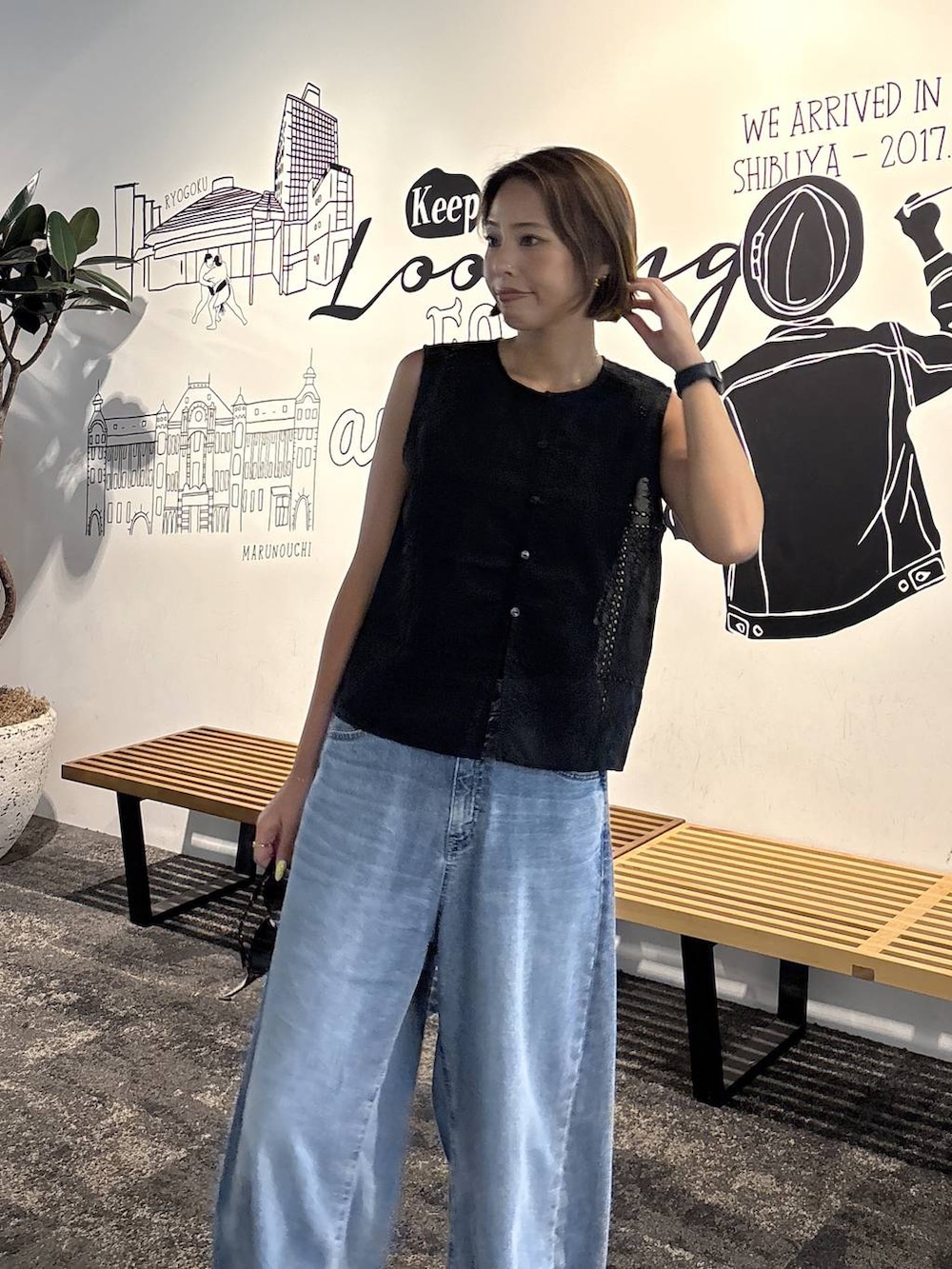 ブラック系のキャミソール、ブルー系のデニムパンツ、ブラック系のベストを着用したレディースの夏コーディネートの6枚目の写真