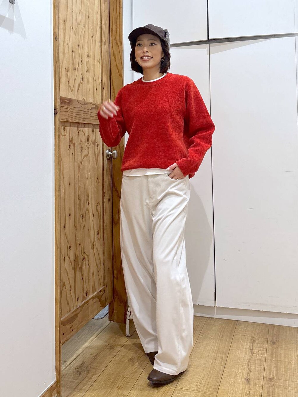 グレー系のその他パンツ、ブラウン系のブーツ、レッド系のニット/セーターを着用したレディースの冬コーディネートの5枚目の写真