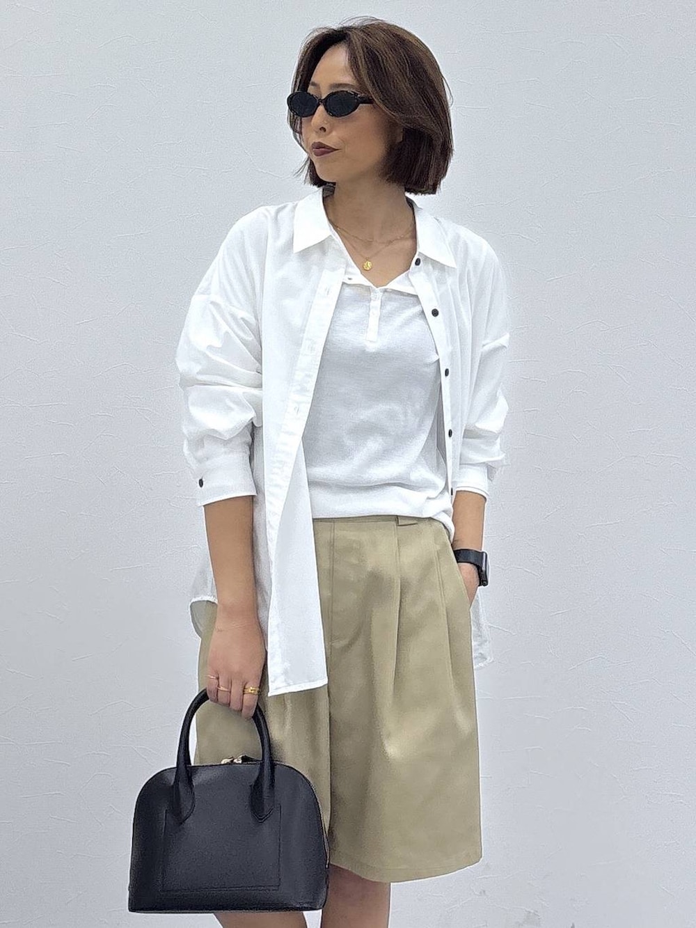 ブラック系のローファー、ブラック系のショルダーバッグ、ホワイト系のシャツ/ブラウスを着用したレディースの春コーディネートの3枚目の写真