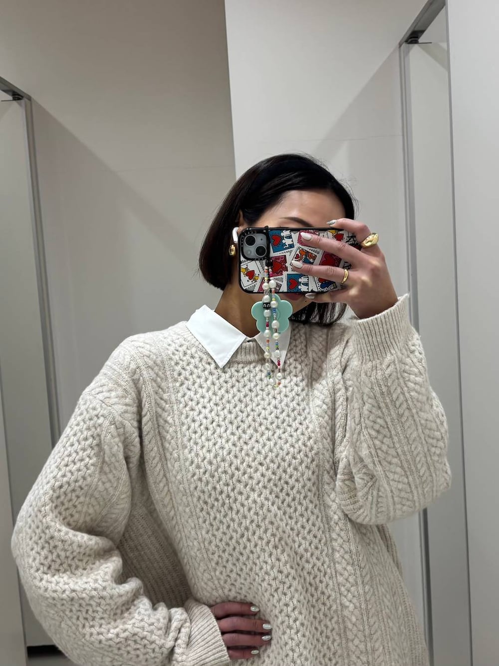 ホワイト系のシャツ/ブラウス、ホワイト系のニット/セーター、ブラック系のカチューシャを着用したレディースの冬コーディネートの2枚目の写真