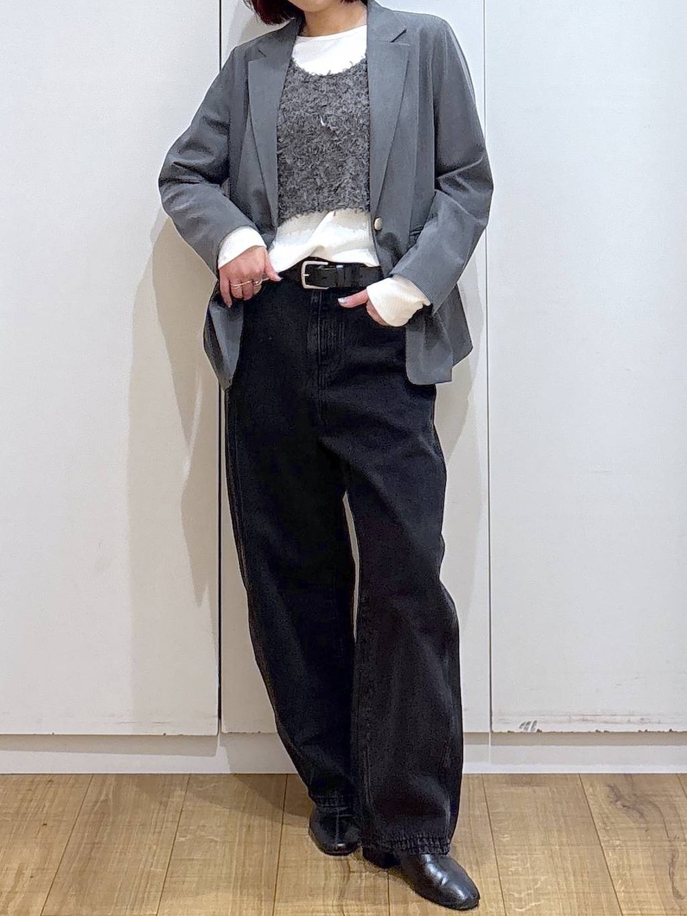グレー系のテーラードジャケット、ブラック系のブーツ、ブラック系のデニムパンツを着用したレディースの春コーディネートの4枚目の写真