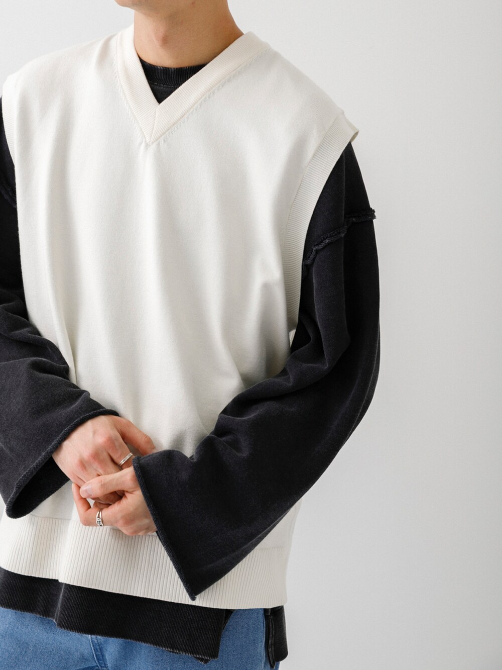 ホワイト系のスニーカー、ブルー系のデニムパンツ、ブラック系のスウェットを着用したメンズの冬コーディネートの2枚目の写真