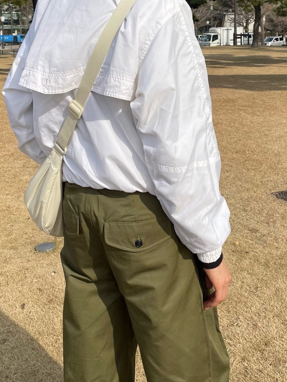 グリーン系のパンツ、グリーン系のその他パンツ、ホワイト系のショルダーバッグを着用したメンズの冬コーディネートの5枚目の写真