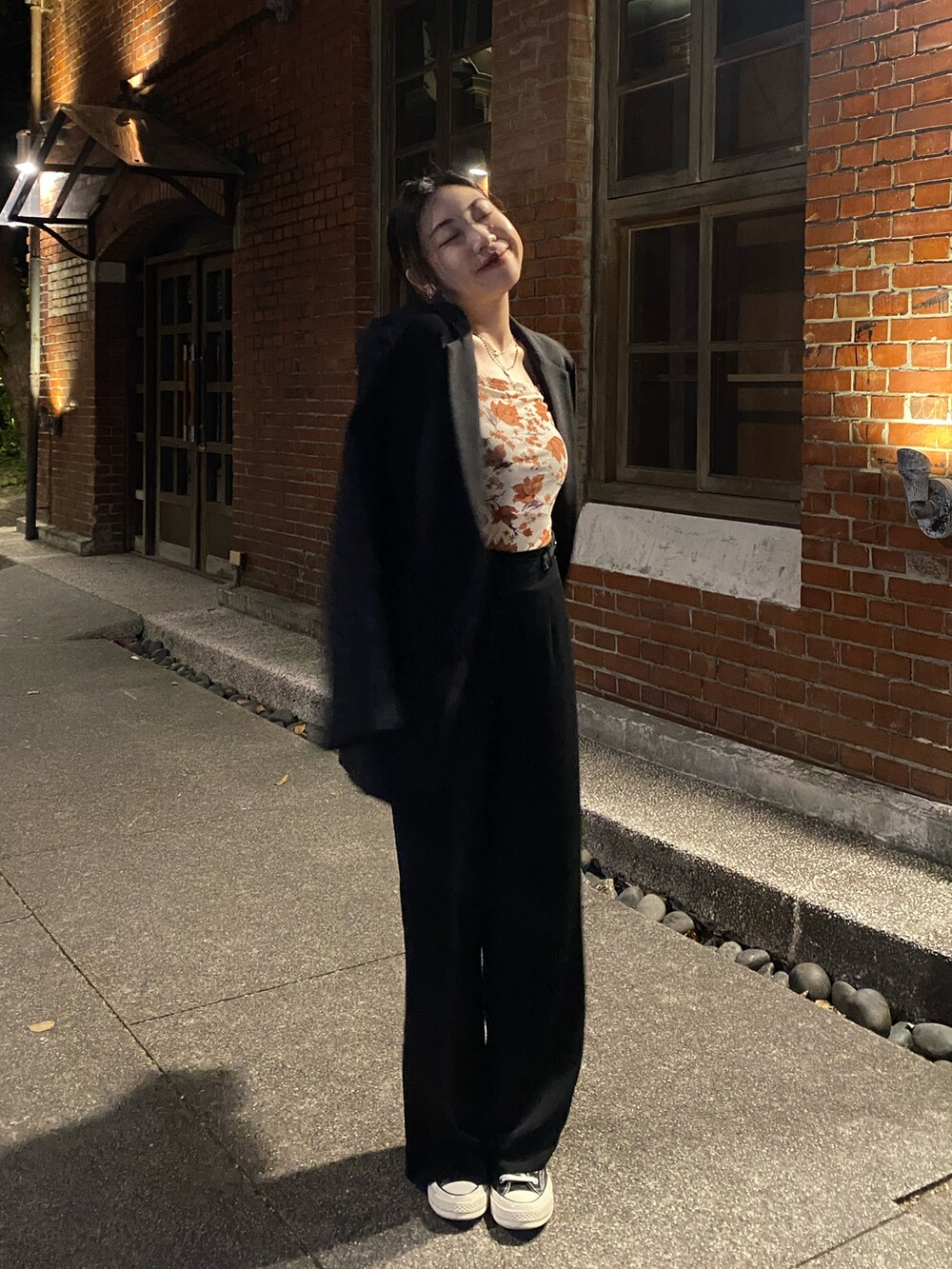 ホワイト系のスニーカー、ブラック系のテーラードジャケットを着用したレディースの冬コーディネートの2枚目の写真