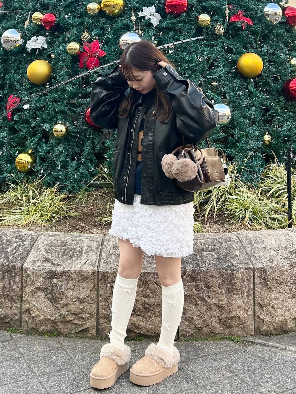 ブラウン系のショルダーバッグ、ホワイト系のスカート、ブルー系のニット/セーターを着用したレディースの冬コーディネートの3枚目の写真