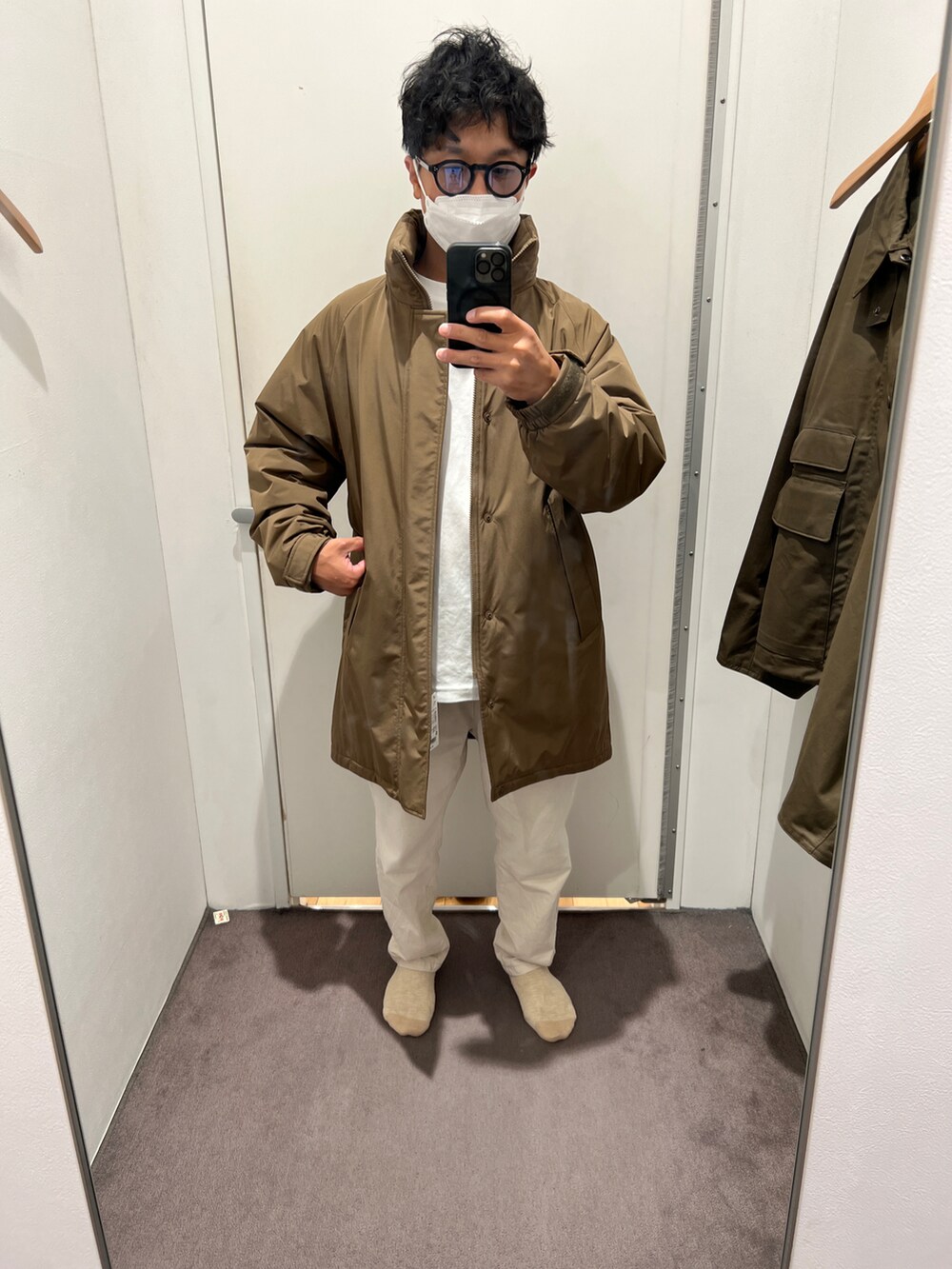 ベージュ系のダウンジャケット/コート、ブラック系のサングラスを着用したメンズの秋コーディネートの2枚目の写真