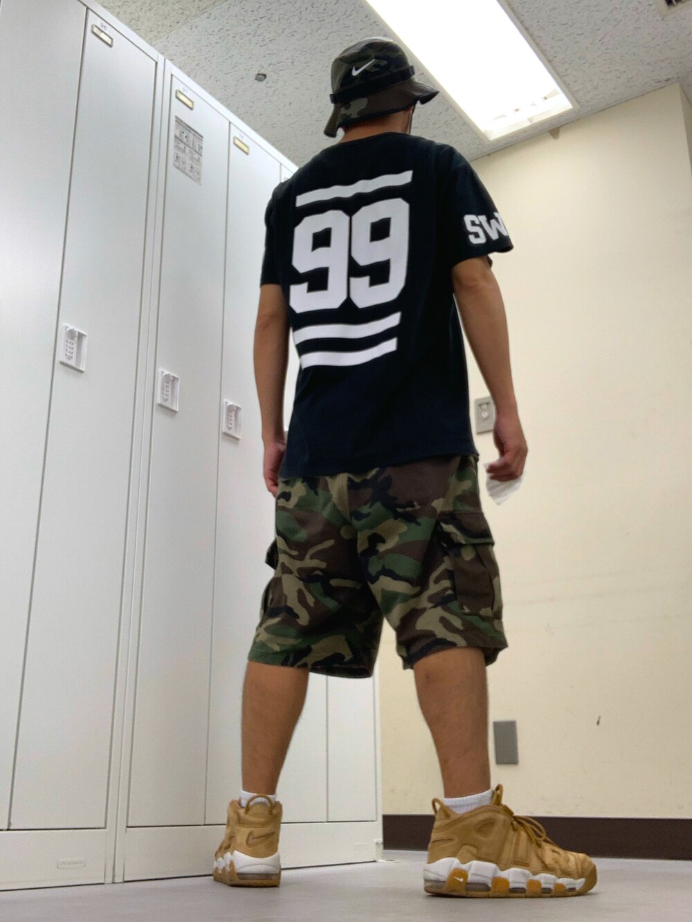 ブラック系のTシャツ/カットソー、グリーン系のカーゴパンツ、ベージュ系のスニーカーを着用したメンズの秋コーディネートの3枚目の写真