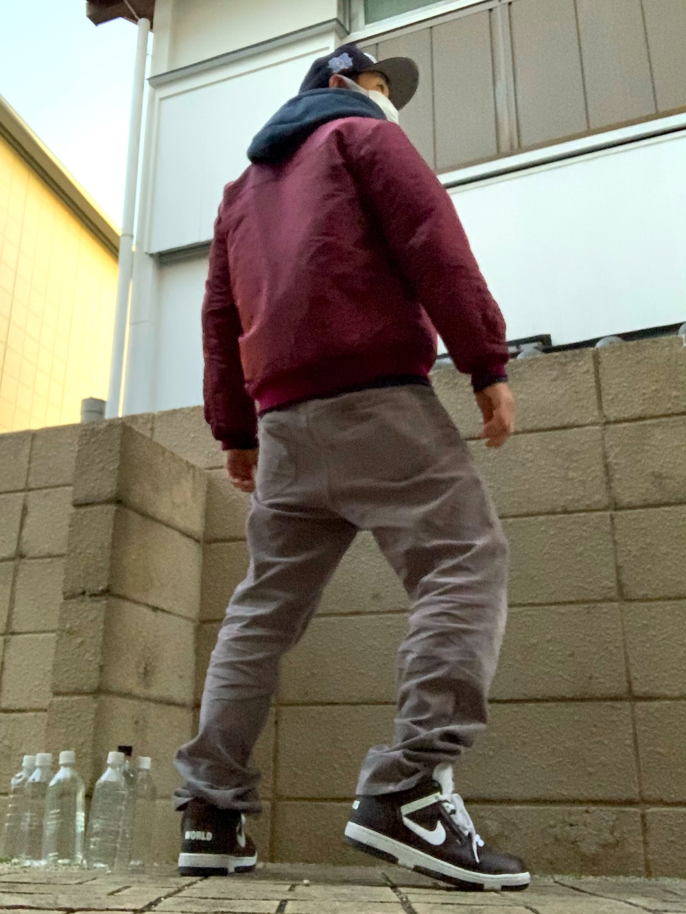 レッド系のミリタリージャケット、グレー系のその他パンツ、ブラウン系のスニーカーを着用したメンズの冬コーディネートの3枚目の写真