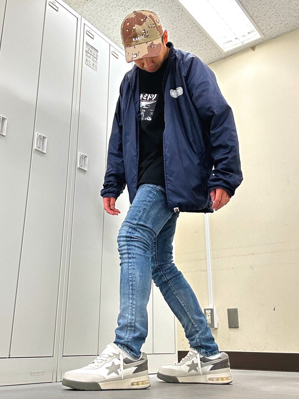 ブルー系のナイロンジャケット、ブラック系のTシャツ/カットソー、ブルー系のデニムパンツを着用したメンズの夏コーディネートの2枚目の写真