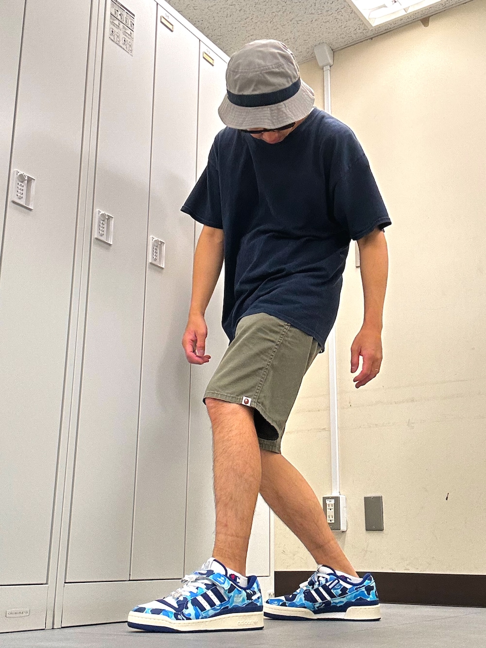 ブルー系のTシャツ/カットソー、グリーン系のチノパンツ、ブルー系のスニーカーを着用したメンズの夏コーディネートの2枚目の写真